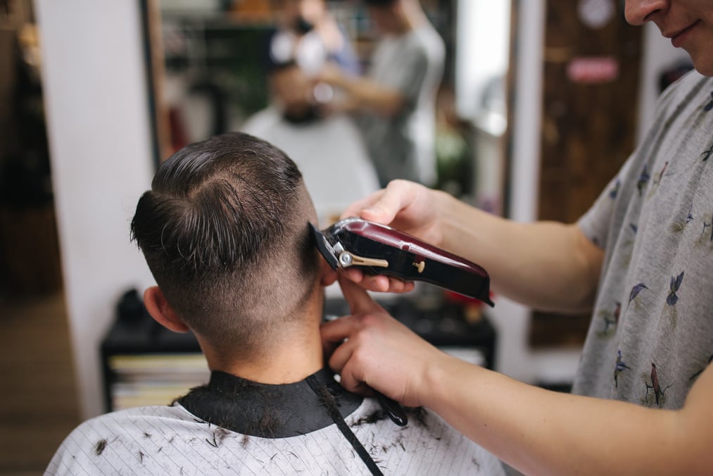 Professional Hairdresser Uses a Hair Clipper for Fringing Hair