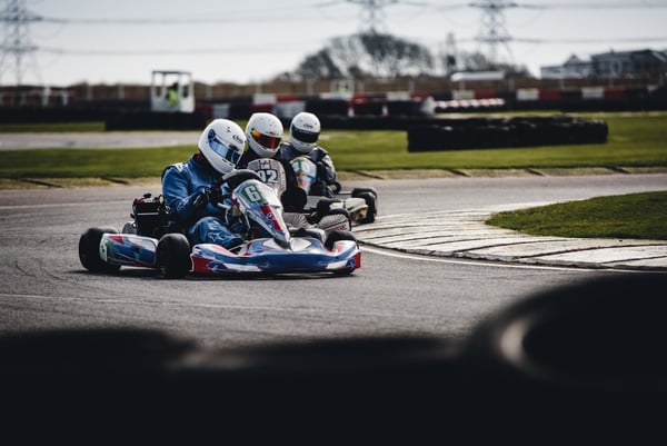 Three Men Riding on Go Karts